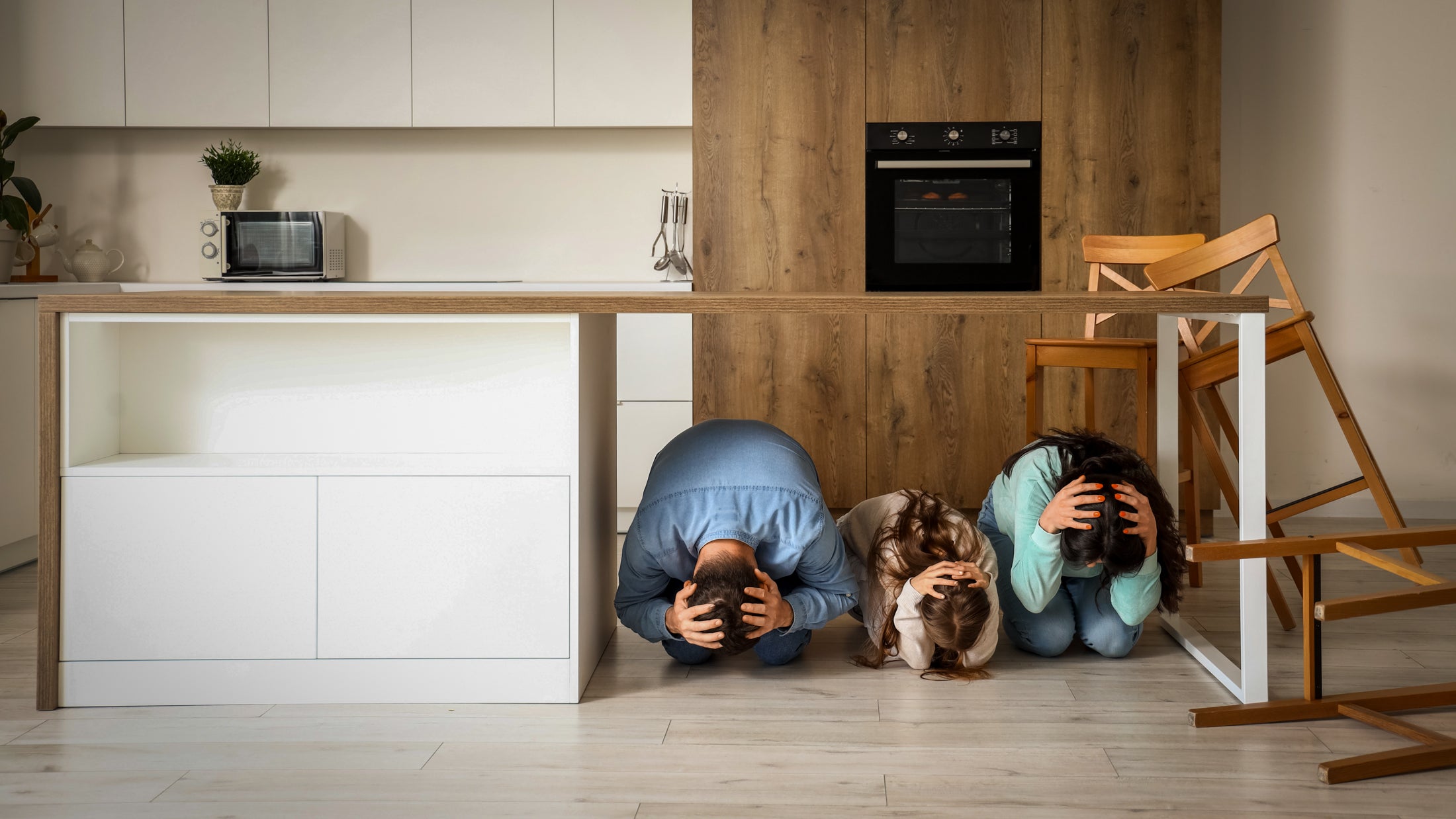 scared-family-hiding-under-table