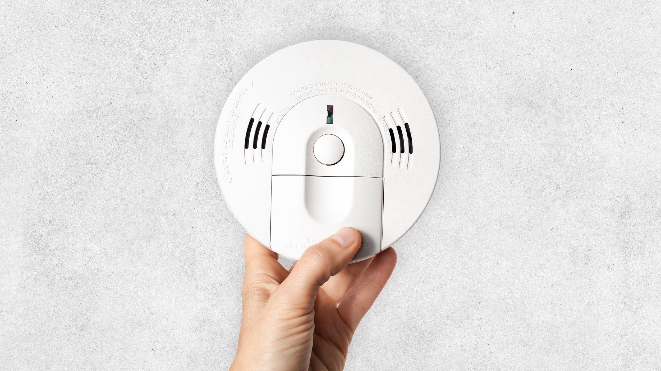 hand-with-smoke-detector